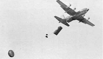 M113 exiting a C-130 as a heavy drop load